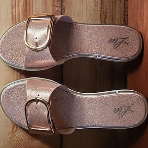 LIA rose gold slides.